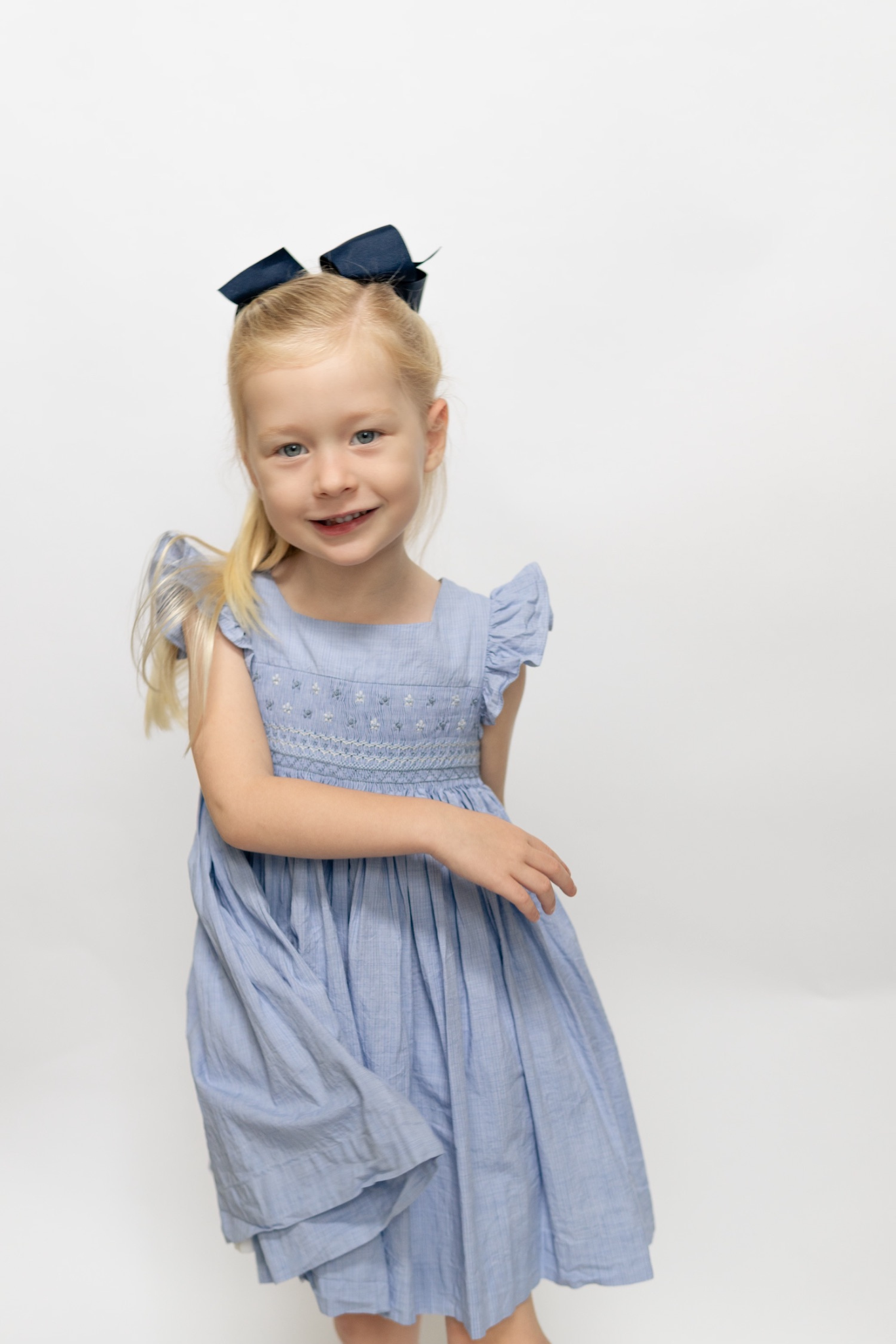 Image Title Charlotte sy Dimby classic timeless traditional smocked dresses for babies and girls handmade French style children clothing paris boutique pastel blue children photography heirloom twirl dress florida